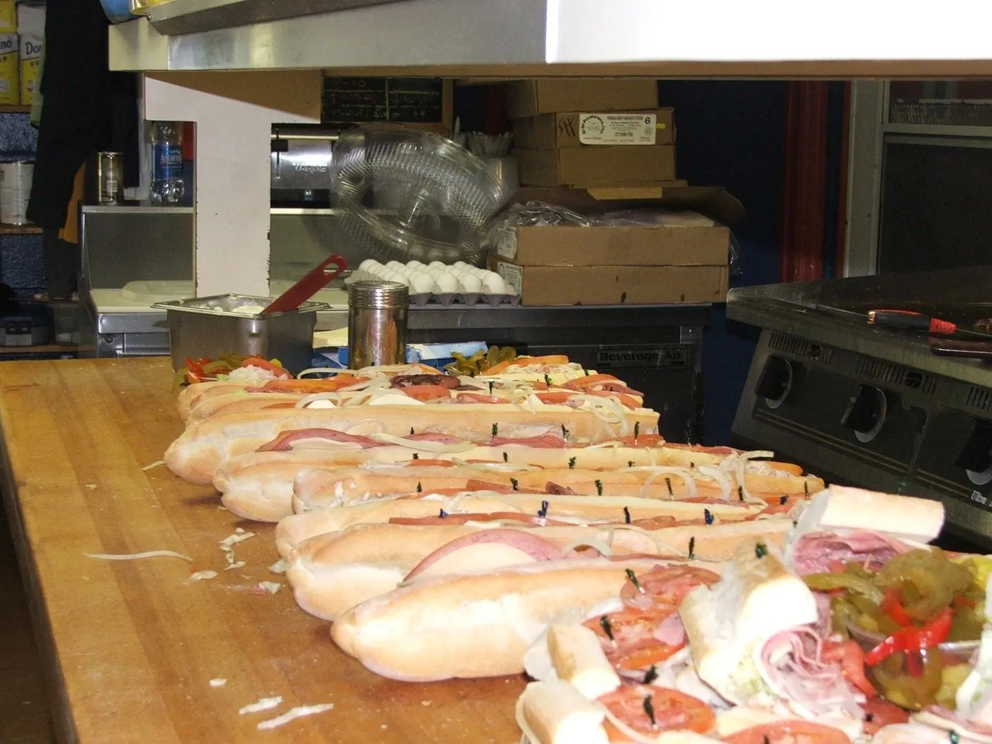 Rows of freshly assembled subs across Sugar Hill's deli counter