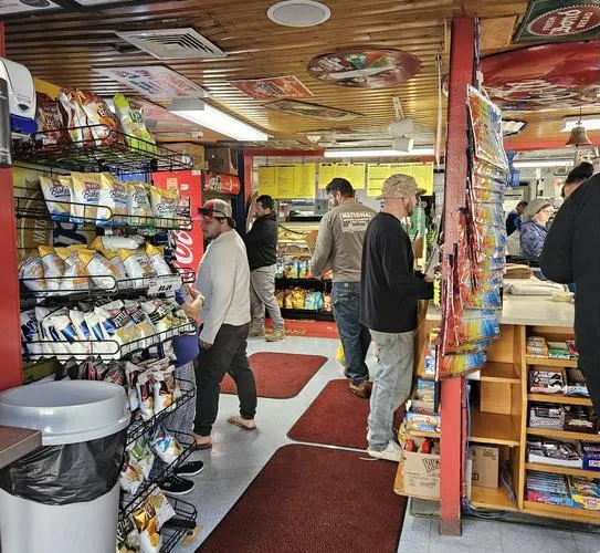 Inside Sugar Hill, with wood-paneled ceilings, old signs and a busy deli counter